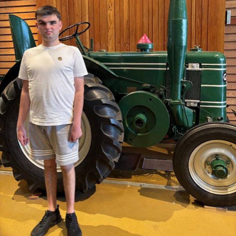 Adam in front of tractor